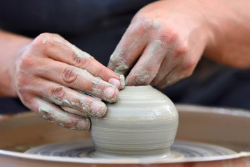 Potter making ceramic pot on the pottery wheel