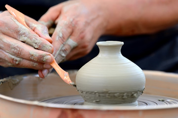 Potter making ceramic pot on the pottery wheel