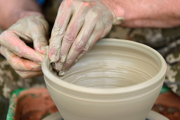 Potter making ceramic pot on the pottery wheel