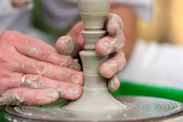 Potter making ceramic pot on the pottery wheel