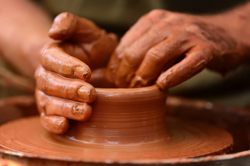 Fototapeta na wymiar Potter making ceramic pot on the pottery wheel