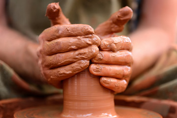 Potter making ceramic pot on the pottery wheel