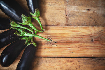 Six ripe eggplant stacked fan on planed boards © glebchik