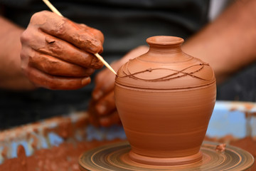 Fototapeta na wymiar Potter making ceramic pot on the pottery wheel