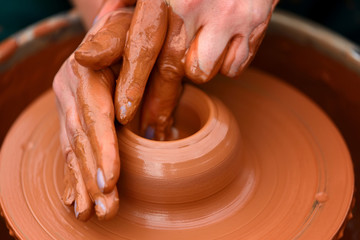 Potter making ceramic pot on the pottery wheel