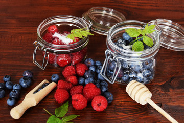 blueberries and raspberries in jars for the winter tea