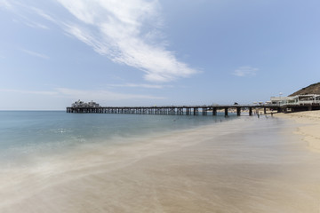 Malibu Pier beach with motion blur water in Los Angeles County, California.  