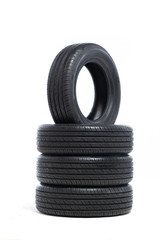 Pile of unused car tires on white background