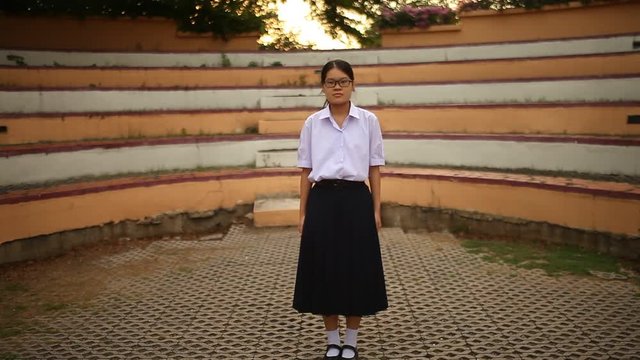 Thai student girl teenager walk through into flame with deep shadow