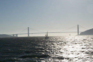 Sailboat in the San Francisco Bay with the Golden Gate Bridge in the background.