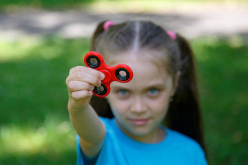 Young girl play with fidget spinner stress relieving toy