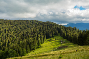 green mountains under a dense clouds