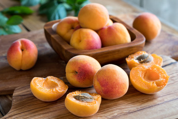 Naklejka na ściany i meble Freshly harvested apricots on a wooden background