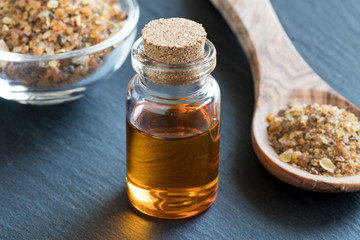 A bottle of myrrh essential oil with myrrh resin