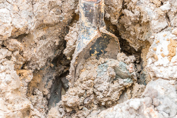 Dig up the clod clay with shovel.