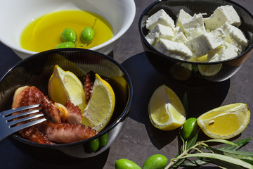 Baked octopus. Traditional Greek snacks. Olives