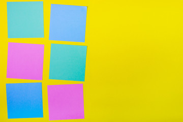 Colorful documents with copy space on a colored background. View from above. For notes and ideas.