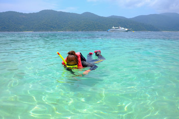 Women dive with a clean sea mask.