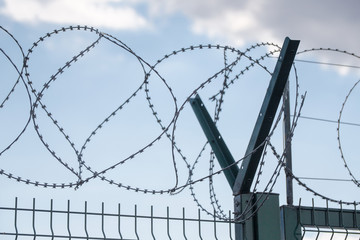 Safe protective metal fence with barbed wire