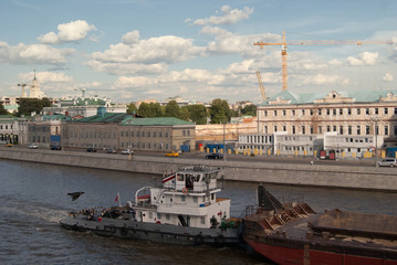 Water transport. River boat tow pusher in the canals of the Moscow river against the backdrop of...