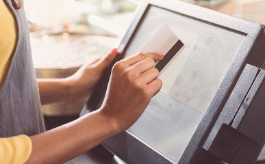 Young woman is making cashless payments transaction