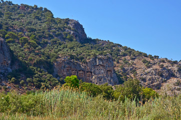 Fototapeta premium The panoramic view of rock tombs at Kaunos antique city at Dalyan, Turkey