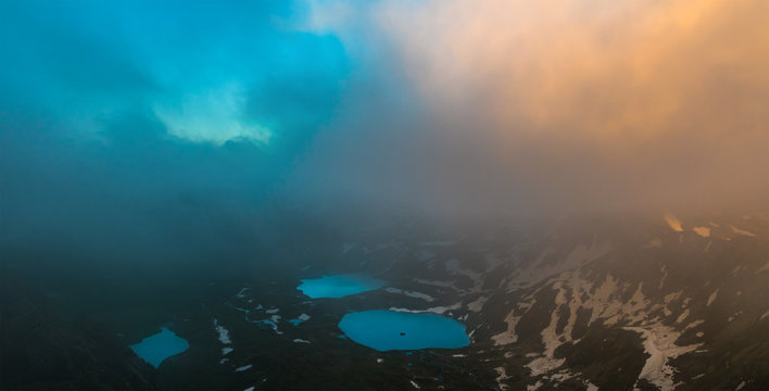 Azgara mountain lakes in last beams of sun. Top view through clouds.  Caucasus mountains.
