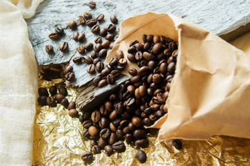 Close up roasted coffee beans in paper bags on wooden background