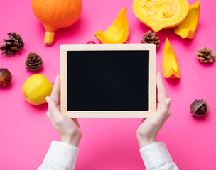 Female hands holding blackboard with vegetables