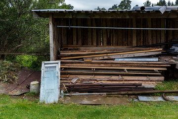 A stack of boards, an old window at the barn in the countryside