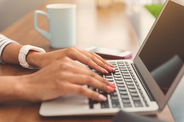 Pleasant girl is working on computer