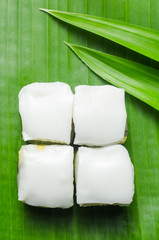 Thai jelly with coconut cream on green banana leaf.