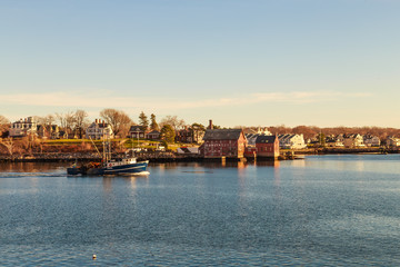 Fototapeta premium Fishing boat and old paint factory on Rocky Neck, Gloucester, MA