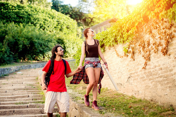 Fototapeta premium Young smiling couple is walking in a touristic tour.