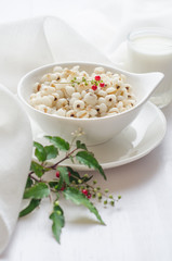 Healthy breakfast with boiled job's tears porridge in white bowl on wooden table.