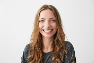 Young cheerful happy girl smiling laughing looking at camera over white background.