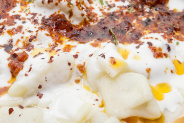 Turkish Ravioli with yogurt and tomato sauce . Plates of traditional Turkish food.