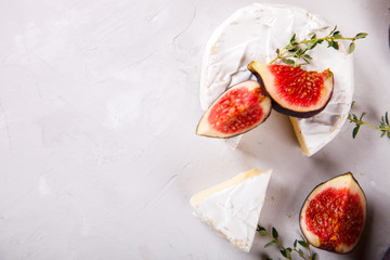 camembert cheese, brie fresh figs and thyme. Snack on a light background.Top View.Copy space for Text.selective focus.