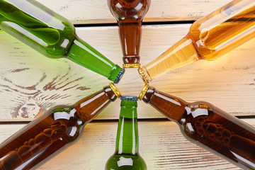 Beer bottles decoration close up. Collection from group of bottles on old wooden background.