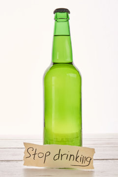 Anti alcoholism concept, wooden background. stop drinking alcohol beverage and start new life.