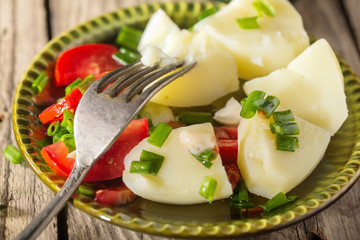 Boiled potato with tomatoes and green onions