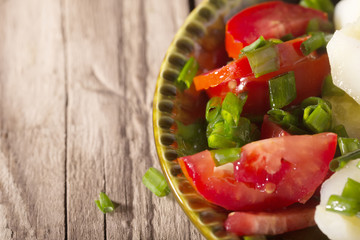 Boiled potato with tomatoes and green onions