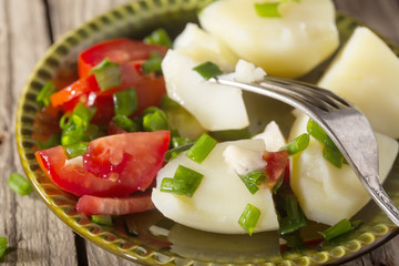 Boiled potato with tomatoes and green onions