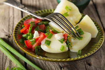 Boiled potato with tomatoes and green onions