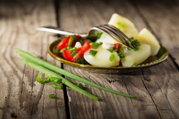 Boiled potato with tomatoes and green onions