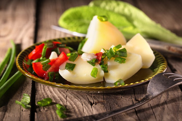 Boiled potato with tomatoes and green onions