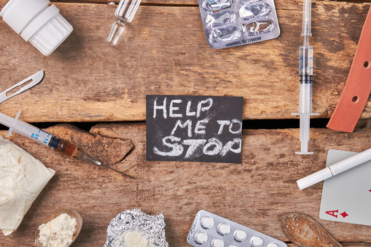 Drug addiction need help. Narcotics, message, old wooden floor.
