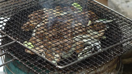 Slow motion South Korean restaurant prepping inshore hagfish for grilling, after remove the skin off a live eel put on BBQ grill. Chef cooked kkomjangeo, grilled food at Jagalchi Fish Market Busan-Dan