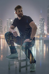 Dreamful young man relaxing near city view