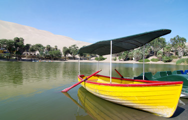 Fototapeta na wymiar Colourful Boat at an oasis in Peru
